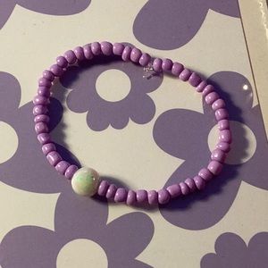 I am selling a pearl purple stretchy bracelet that will go great with any outfit